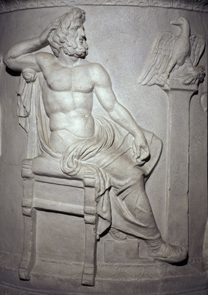 Marble relief of the god Zeus, bearded and half-nude, seated next to an eagle perching with thunderbolts in its talons.